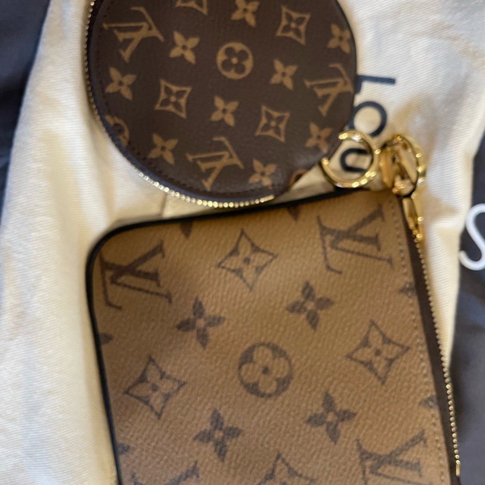 Two Louis Vuitton pouches . One reverse monogram and on round monogram .
